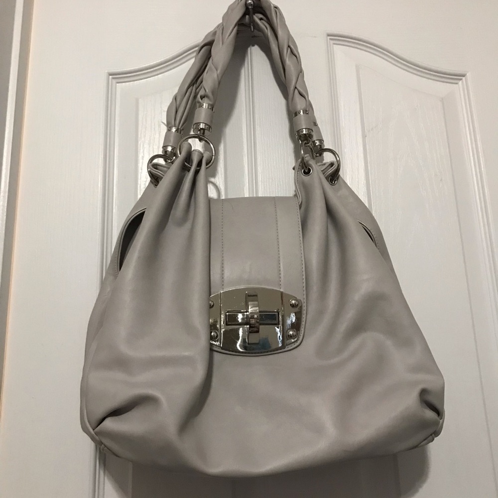 Charming Charlie shoulder bag purse with braided straps. Three large pockets.